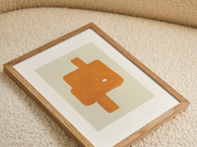 A natural wooden frame resting on a textured rug